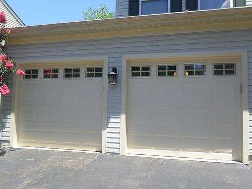 A white garage door with a light on the side of it