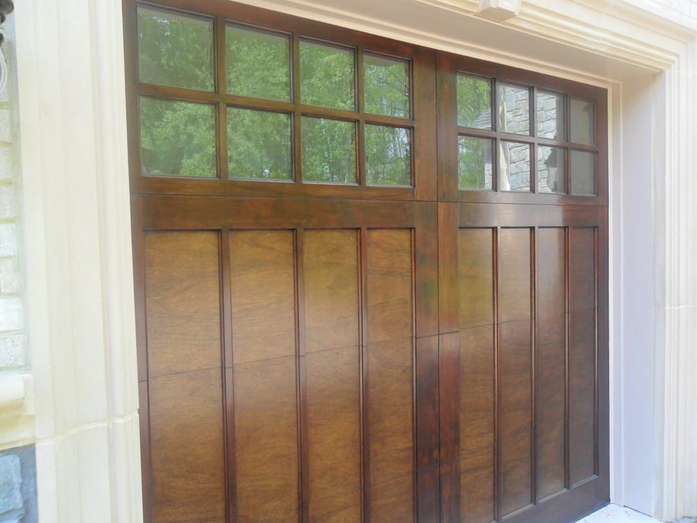 A wooden garage door with a lot of windows on it